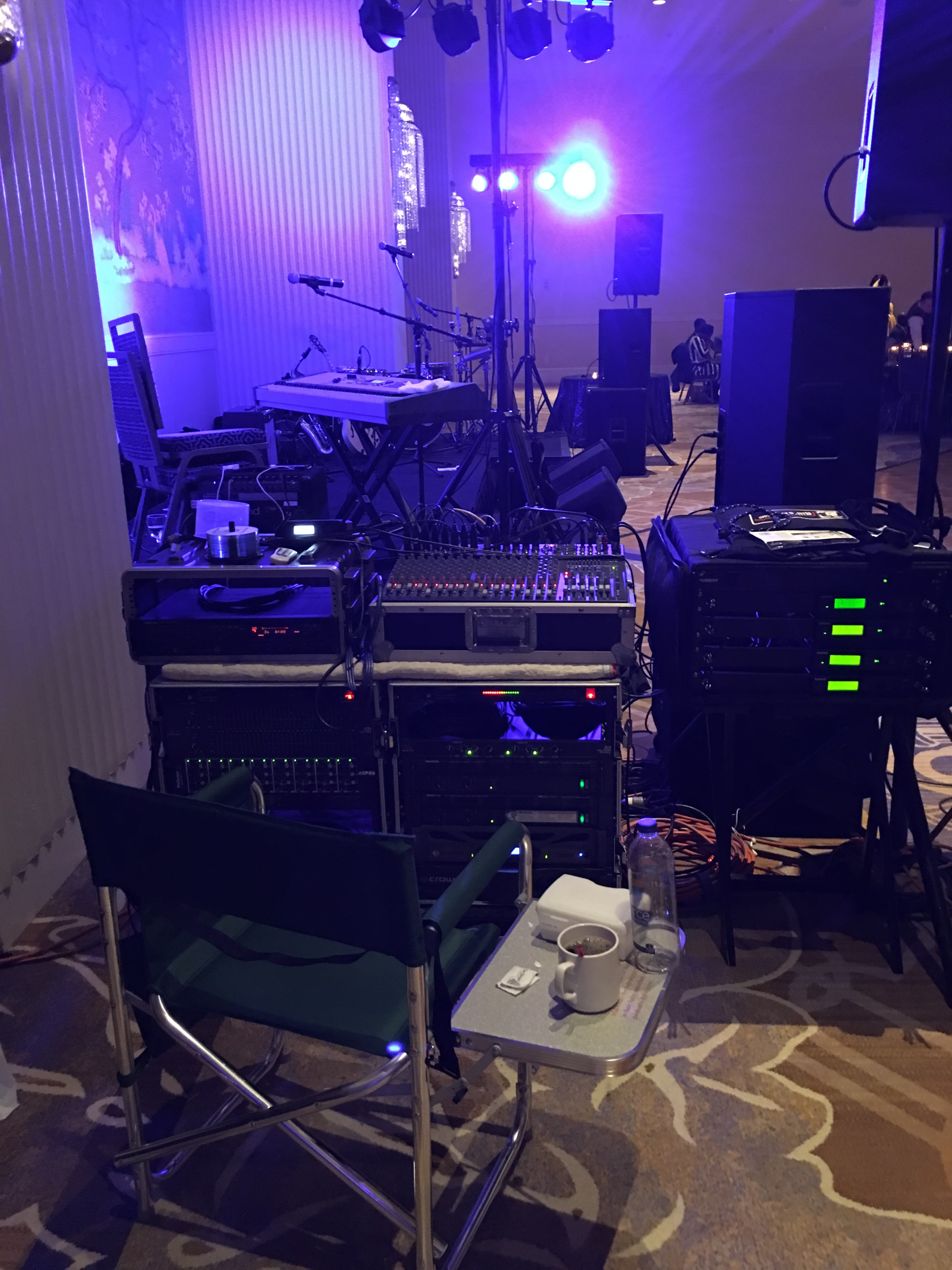 DJ equipment setup with purple stage lighting