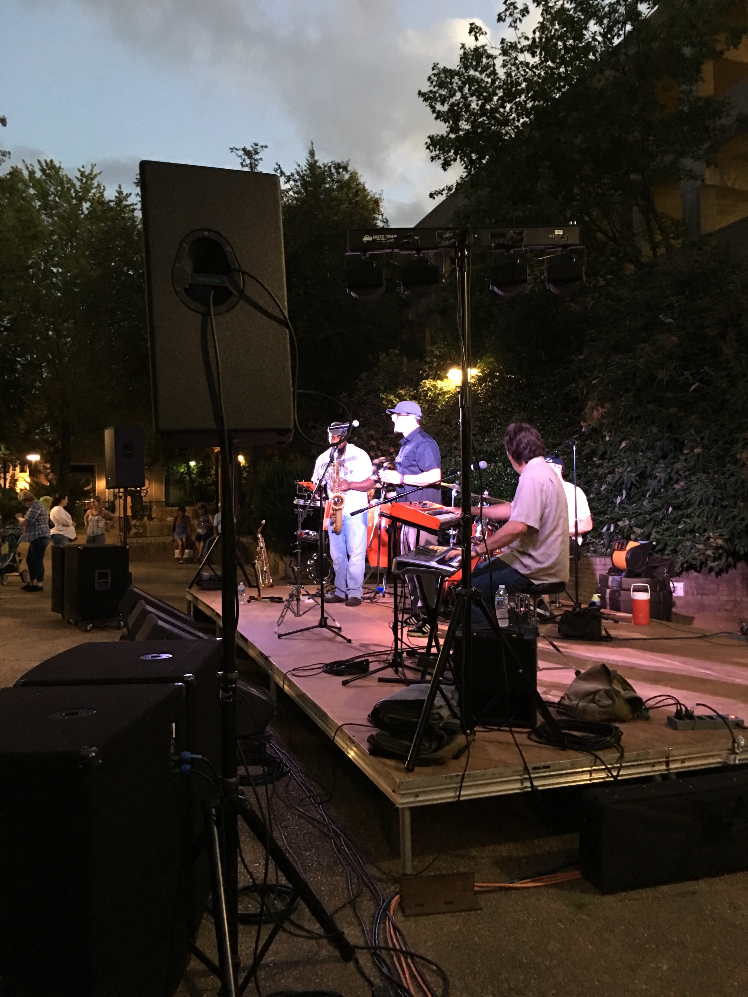 Outdoor band performing on stage at evening