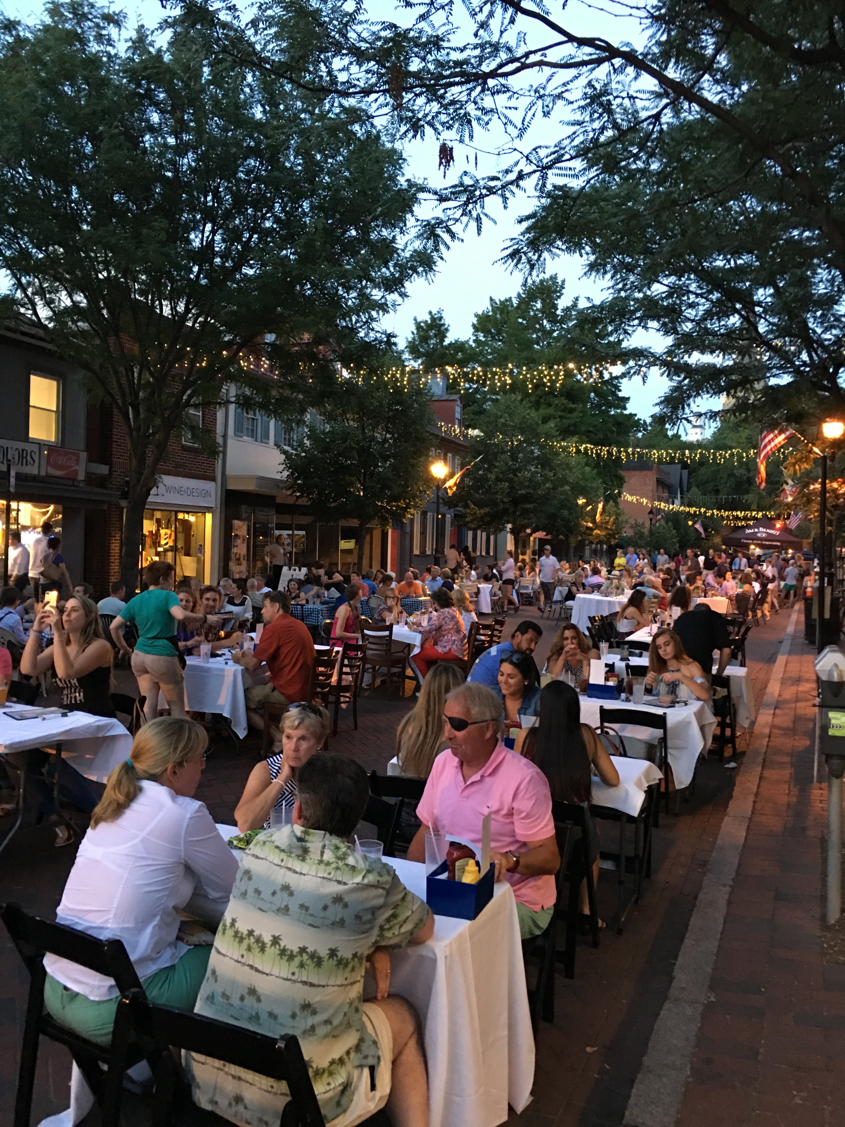 Outdoor street dining event at dusk