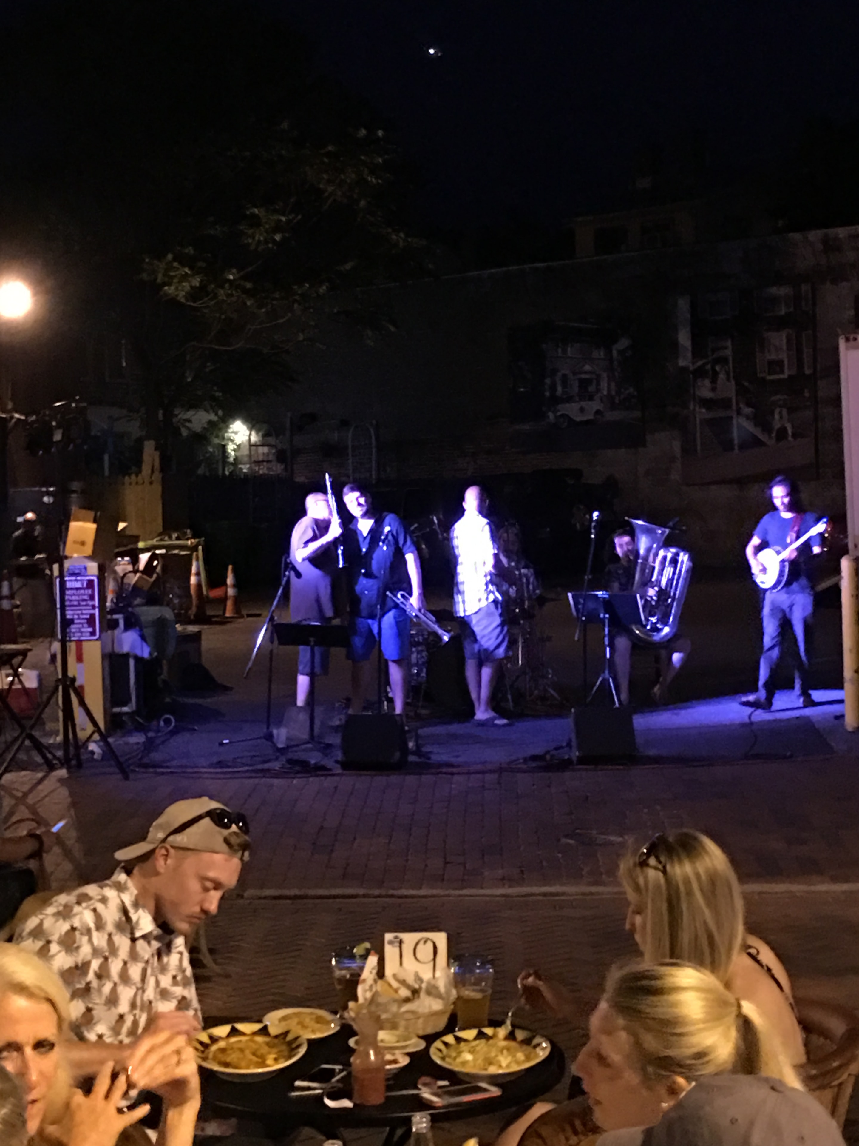 Live band performing outdoor street concert at night