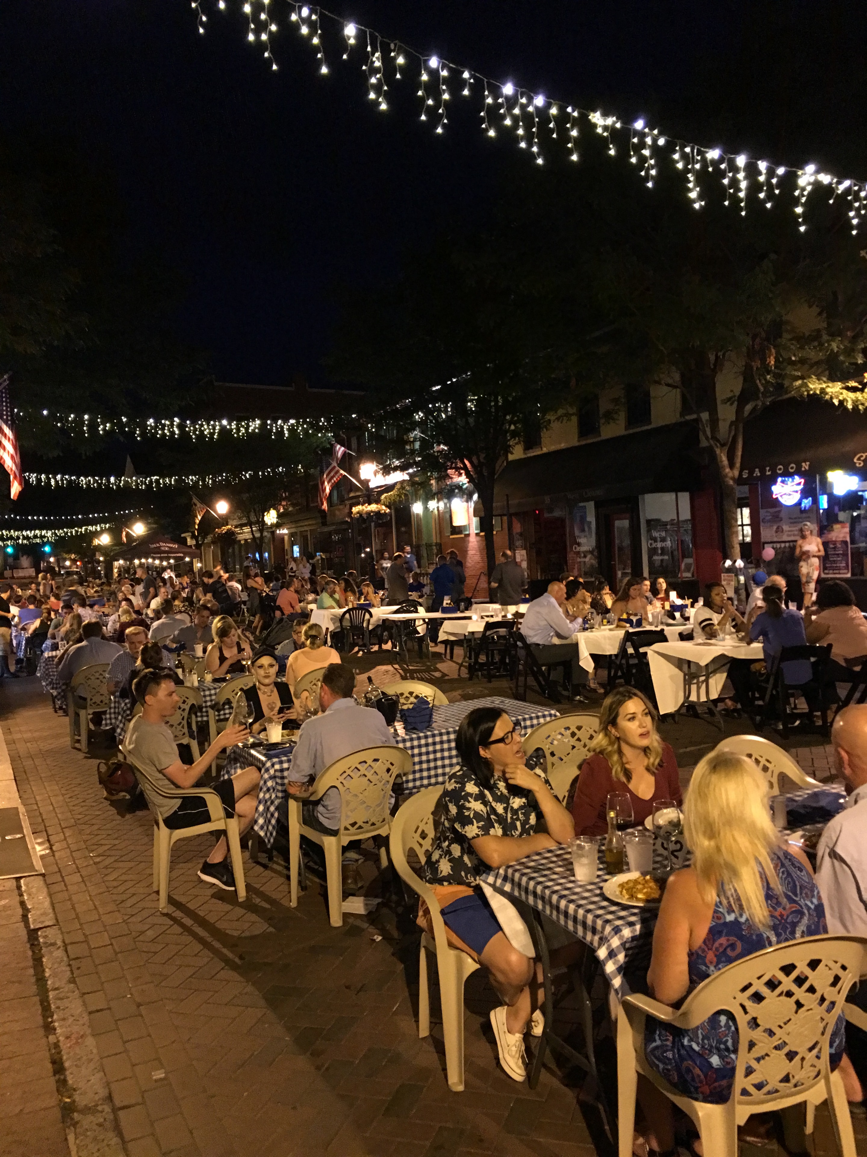 Outdoor street dining with festive lights