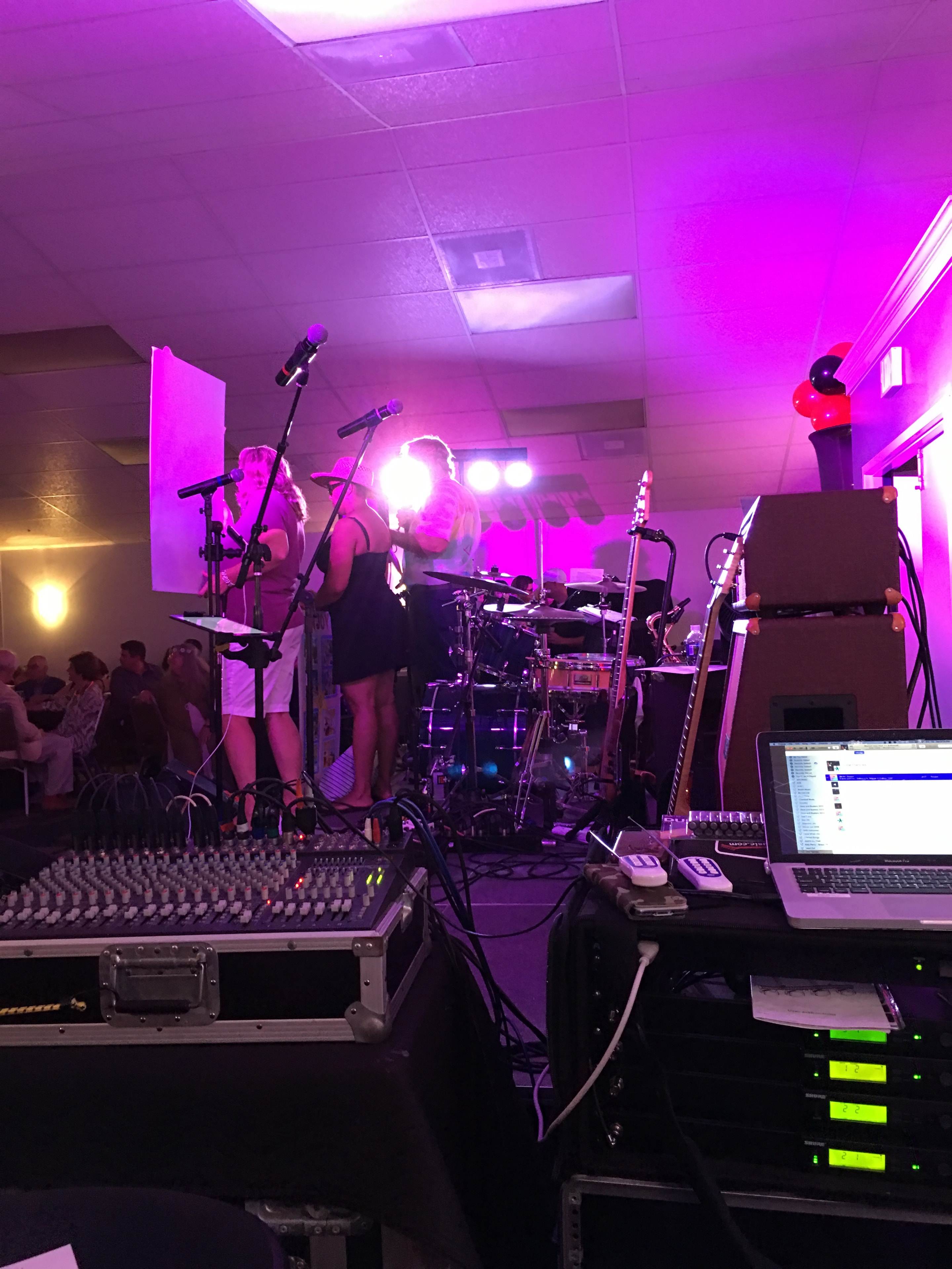 Music production studio with magenta stage lighting