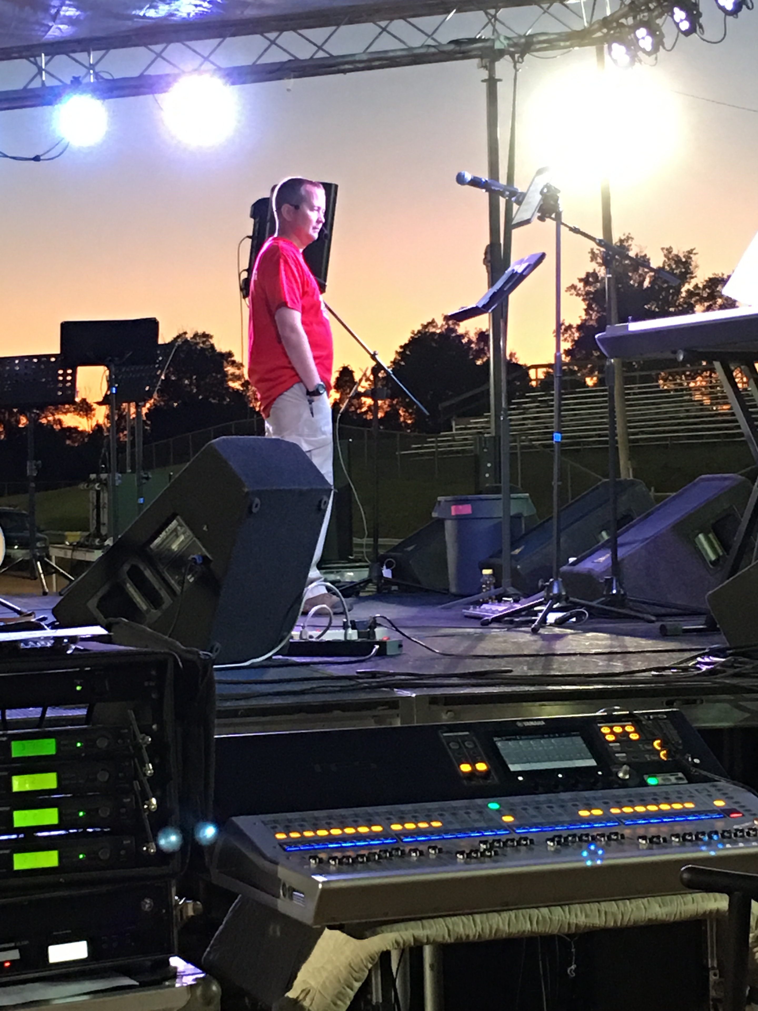 Sound engineer at outdoor stage at dusk