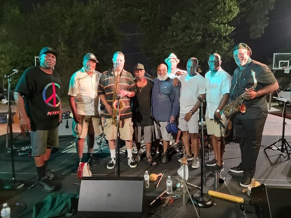 Music ensemble performing outdoors at night