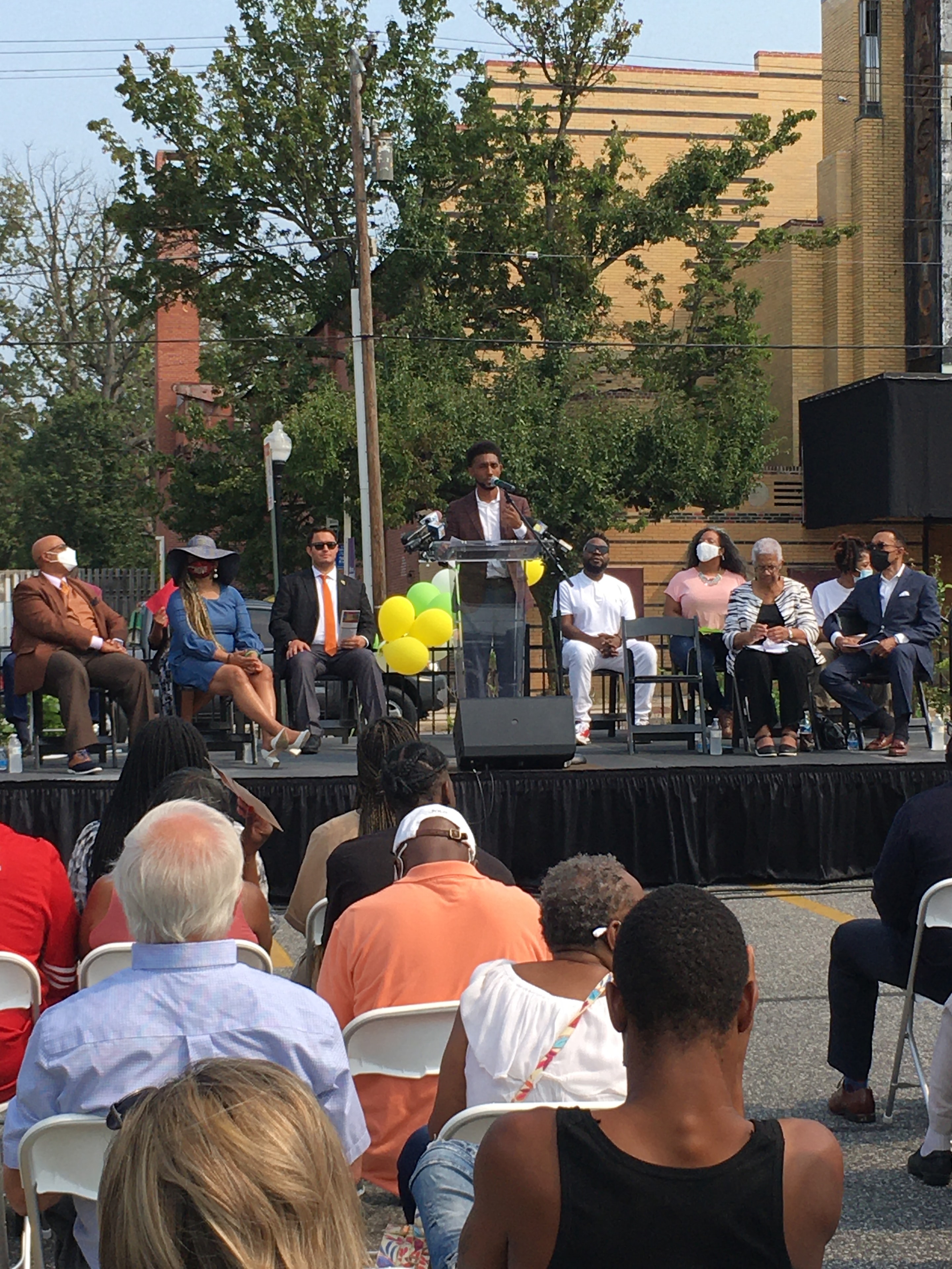 Outdoor community event with stage and audience
