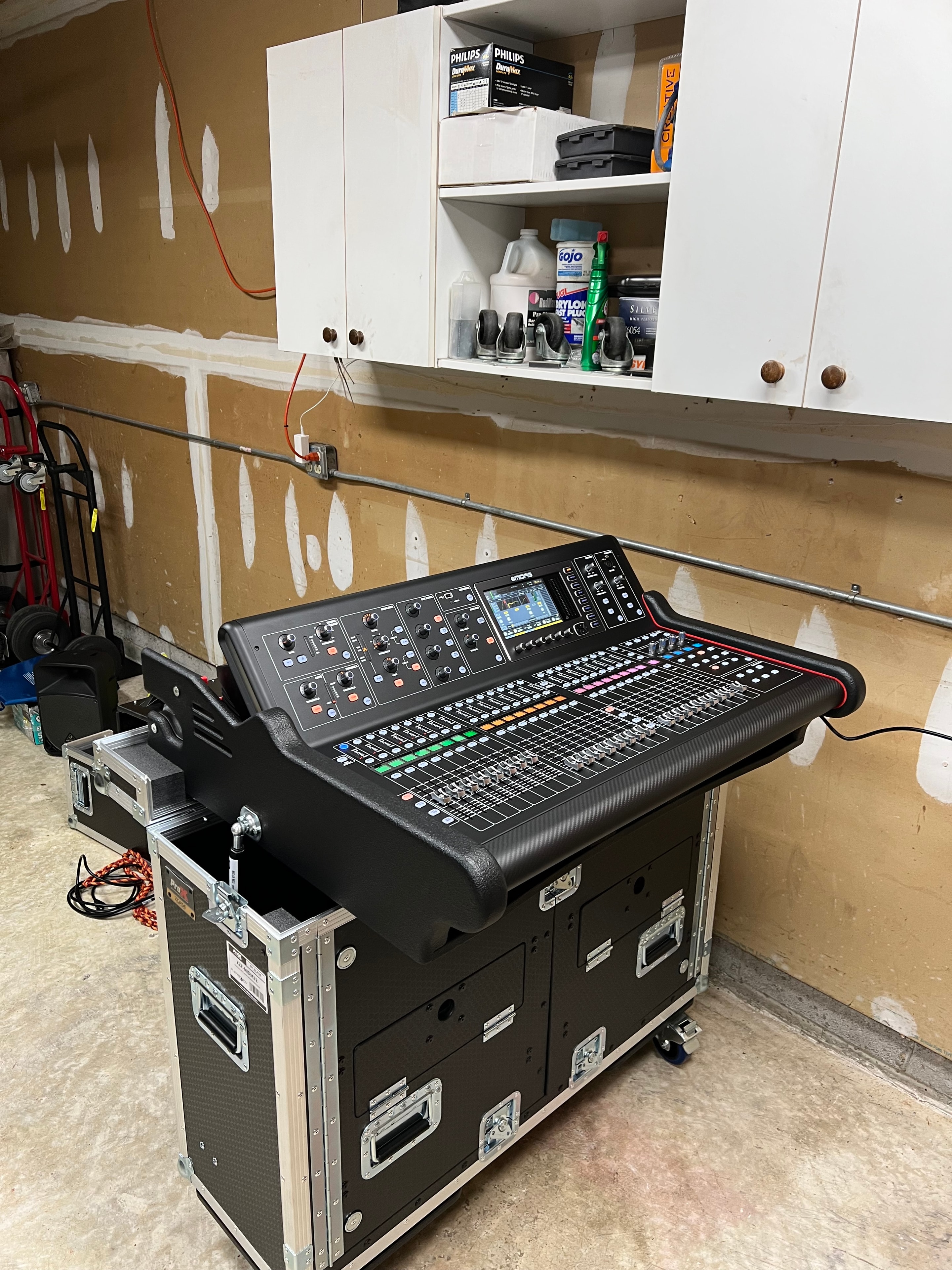 Professional audio mixer and road cases in garage