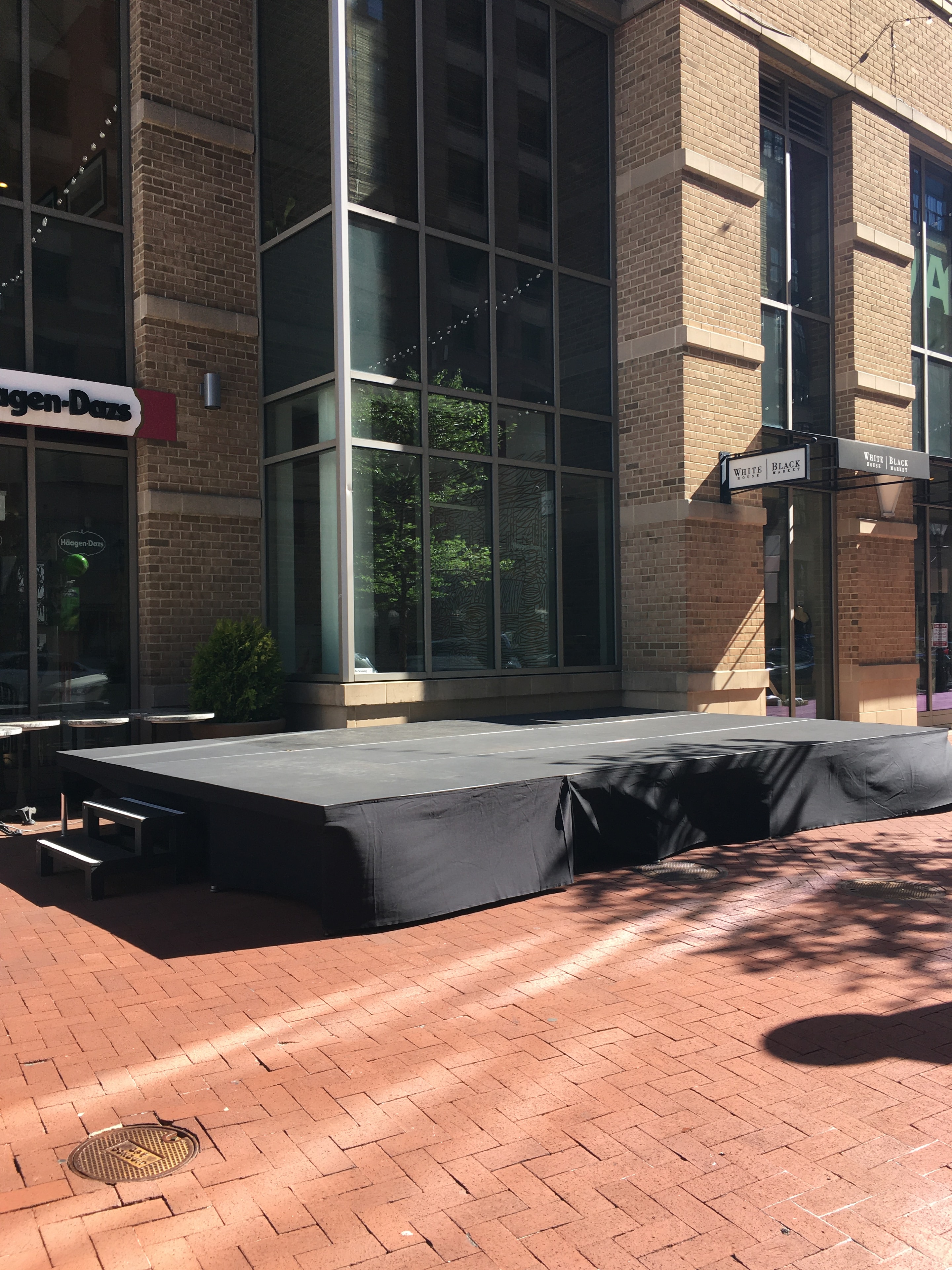 Urban street venue setup with stage canopy